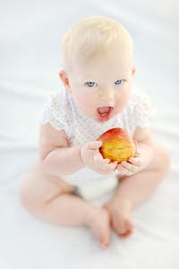 Baby eating a healthy apple